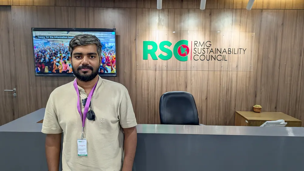 Standing in front of the RMG Sustainability Council reception wall