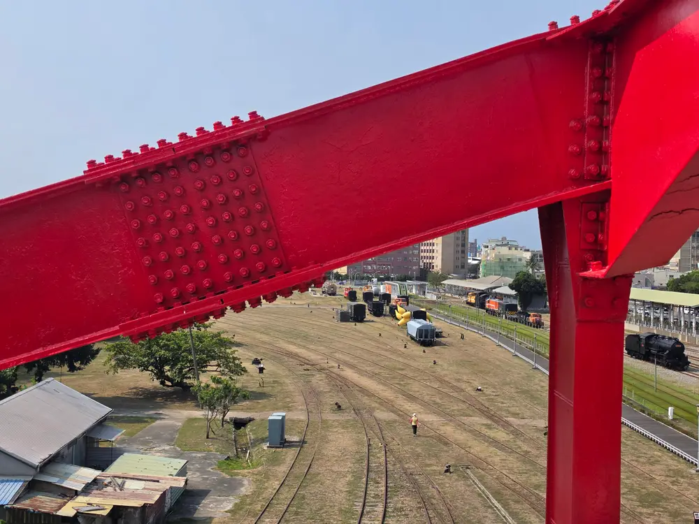 Close-up of a riveted red steel beam connection